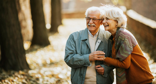 senior-couple-walking-in-autumn-park senior-couple-walking-in-autumn-park